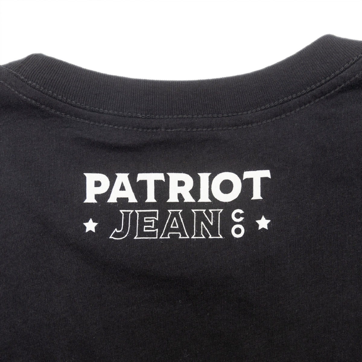 The Motto tee, Black, back neck logo close-up